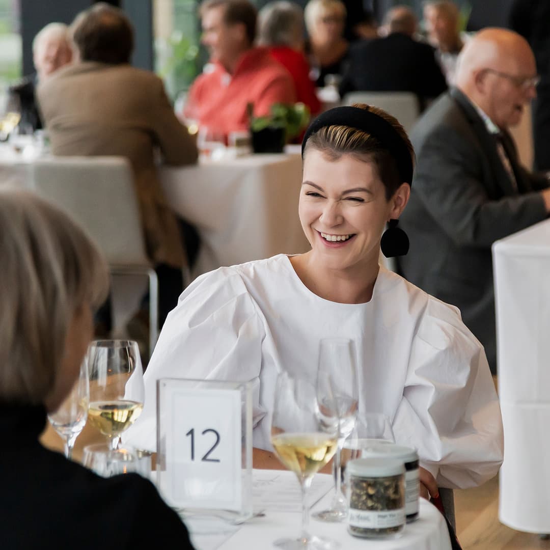 Woman laughing while dining at the restaurant
